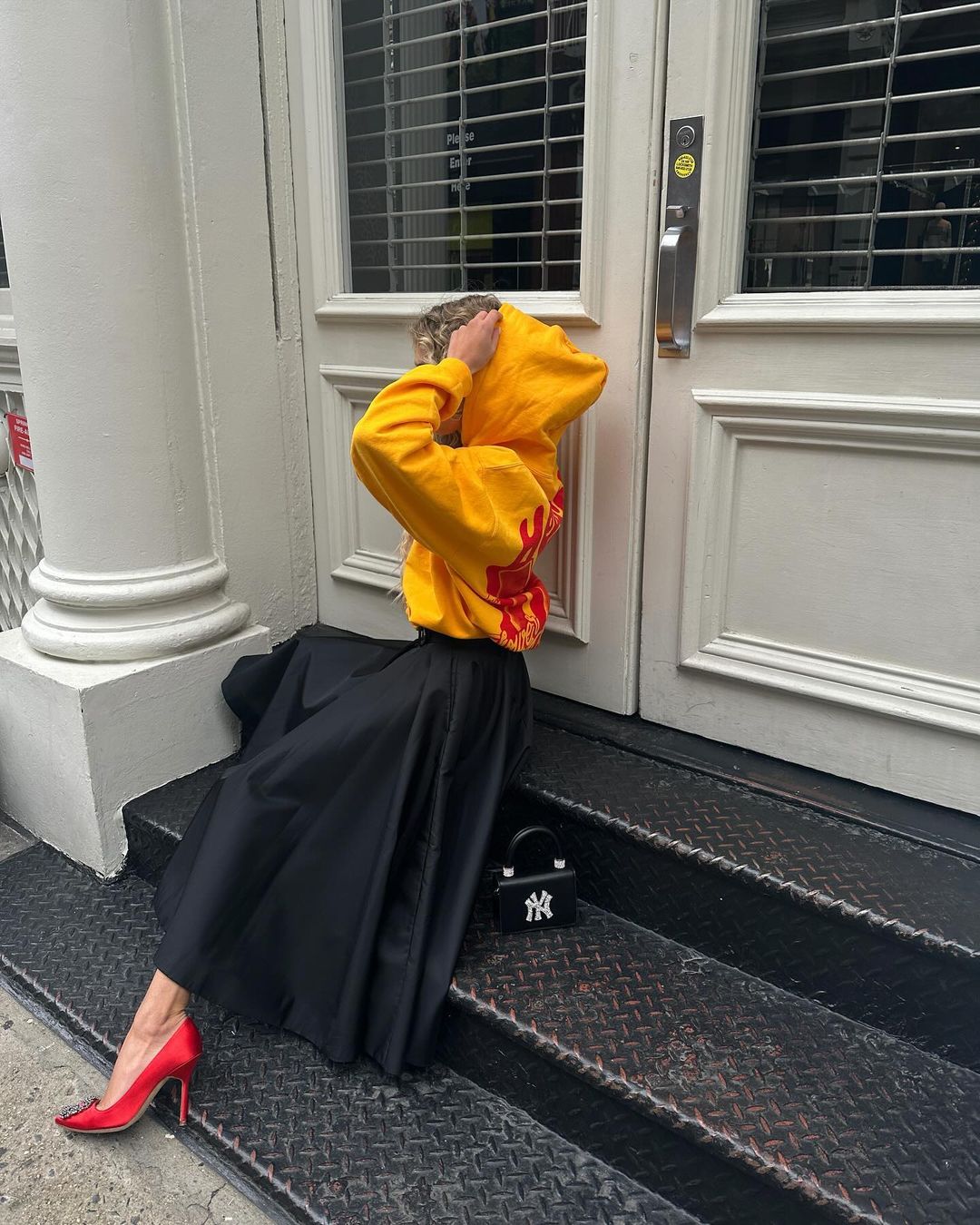 Denmark European influencer Emili Sindlev wears Thirteen Crosby NY New York Yankees yellow hoodie.