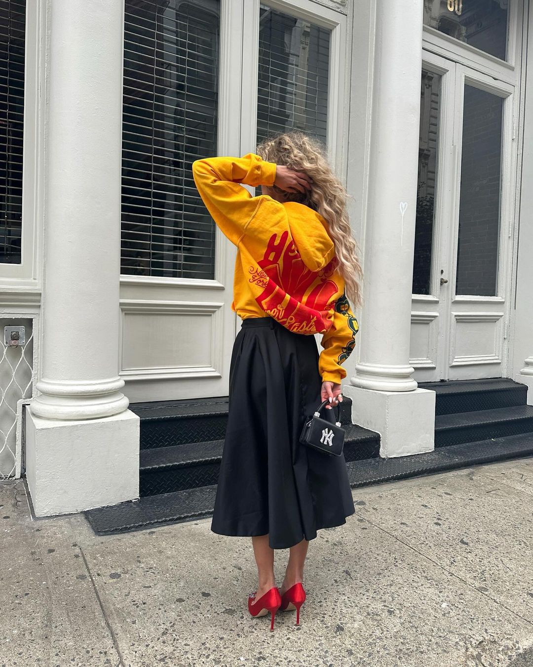 Denmark European influencer Emili Sindlev wears Thirteen Crosby NY New York Yankees yellow hoodie.