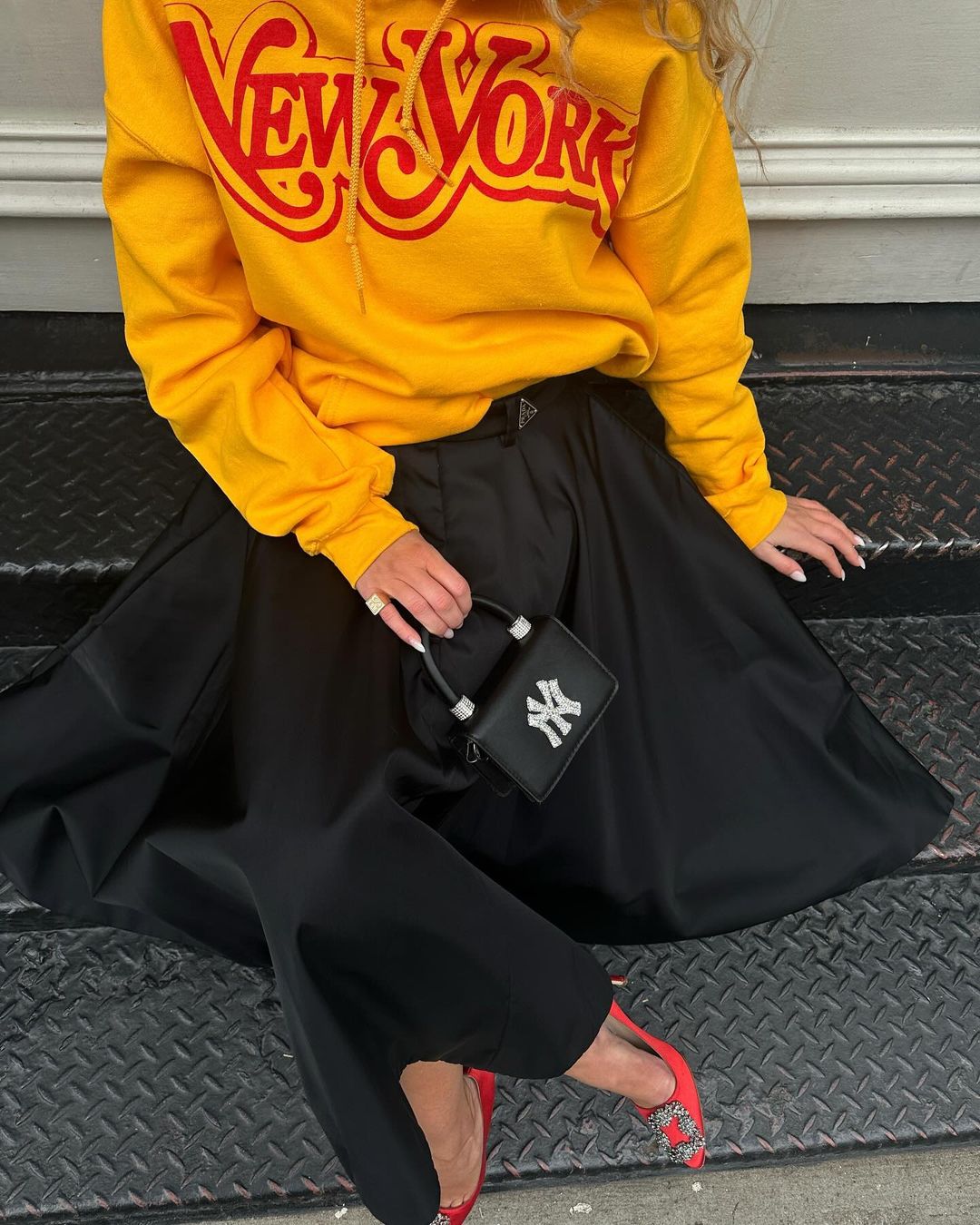 Denmark European influencer Emili Sindlev wears Thirteen Crosby NY New York Yankees yellow hoodie.